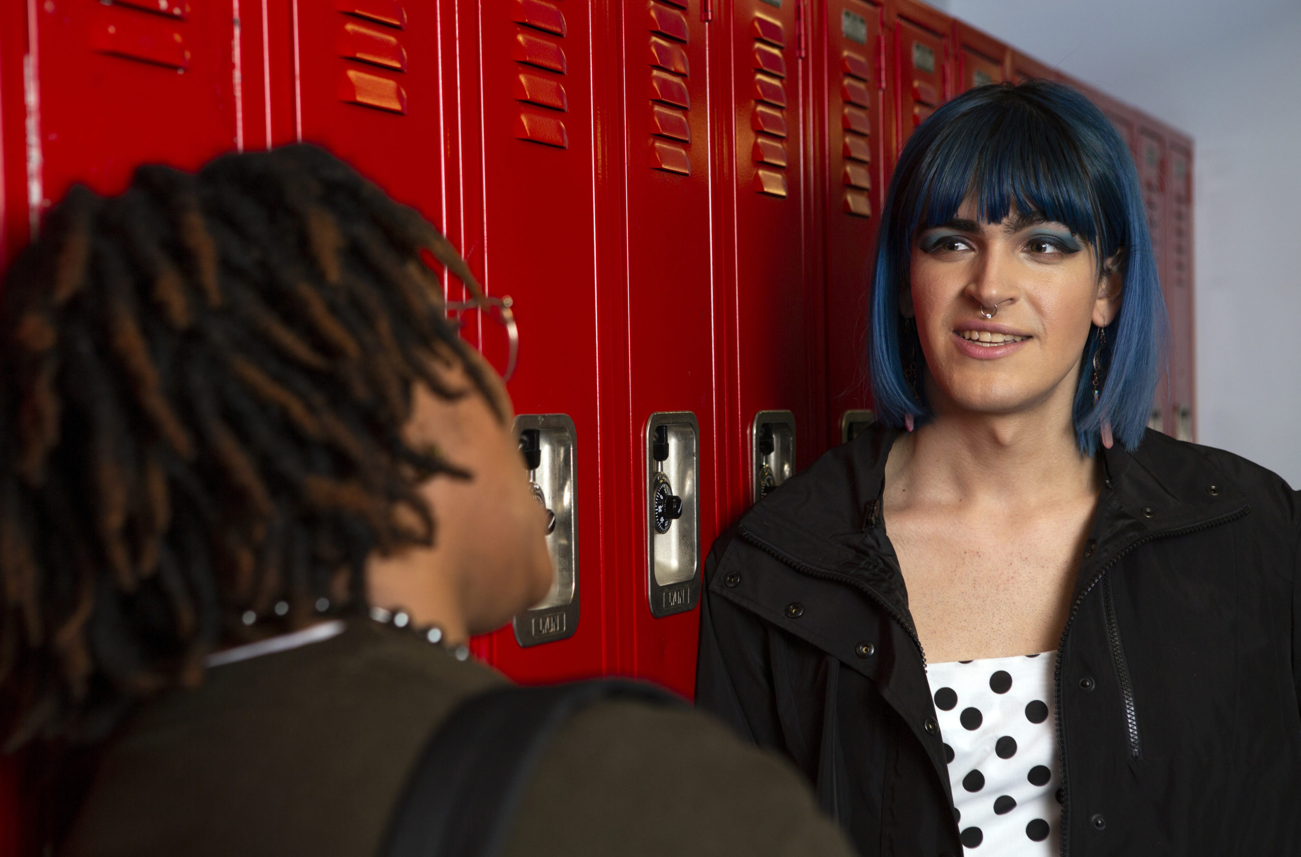 Students speaking in front of school lockers