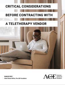 young man sitting in chair smiling while having a teletherapy session via his laptop